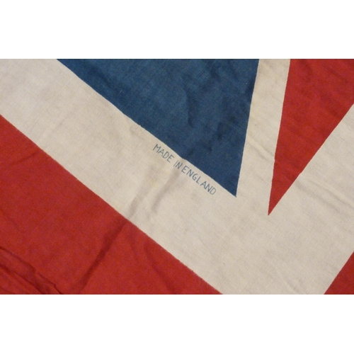 941 - A Union Jack flag, military and other badges including one mounted