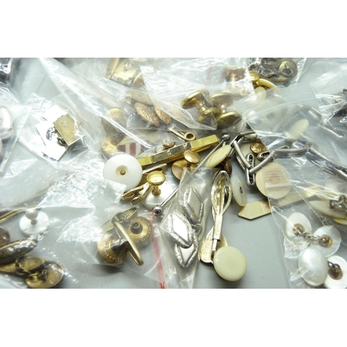 951 - A collection of tie-pins, cufflinks, shirt sleeve bands, etc.