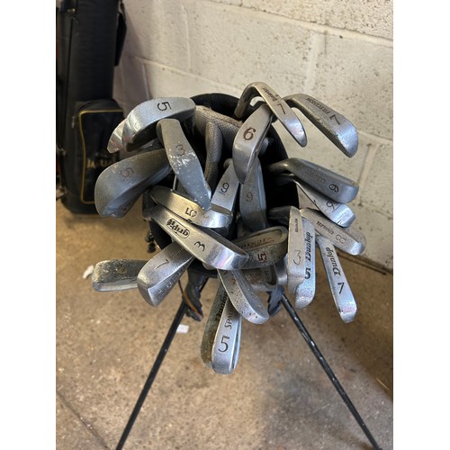 2203 - Three golf bags with clubs