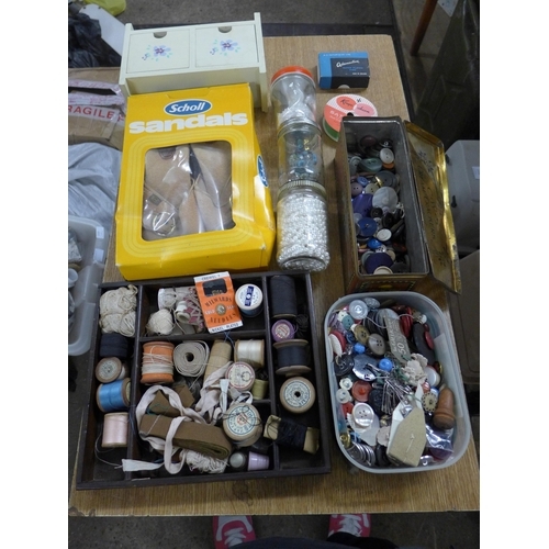 2341 - A box of mixed haberdashery, clothing, beads, vintage cotton reels, doll figure, etc.