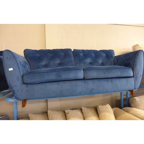 1601 - A Hoxton blue velvet three seater sofa, damaged