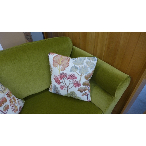 1567 - A moss green velvet love seat with Japanese garden embroidered scatter cushions