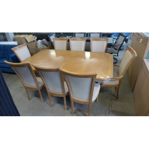 1600 - An American ash dining table and eight chairs