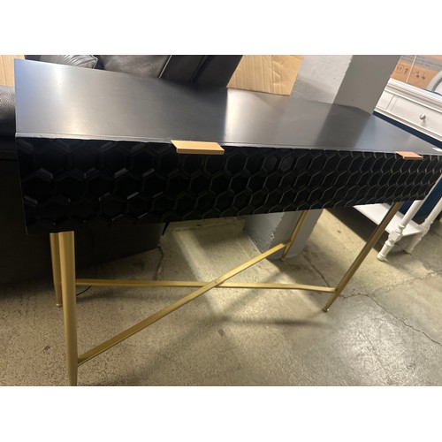 1605 - A black console table with gold legs