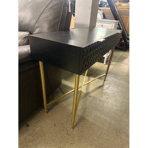 1605 - A black console table with gold legs