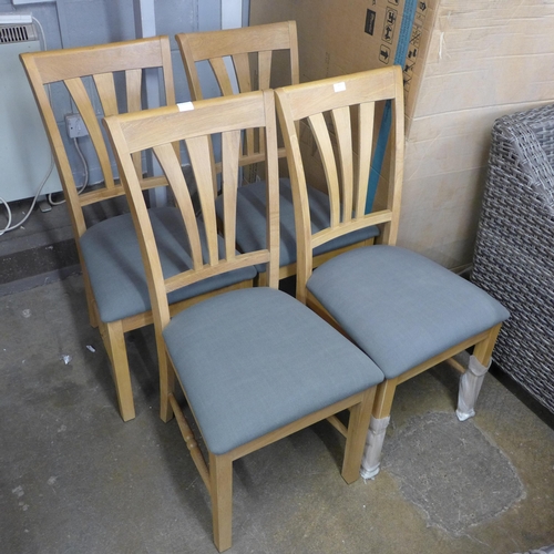 1506 - A set of four natural oak and upholstered dining chairs