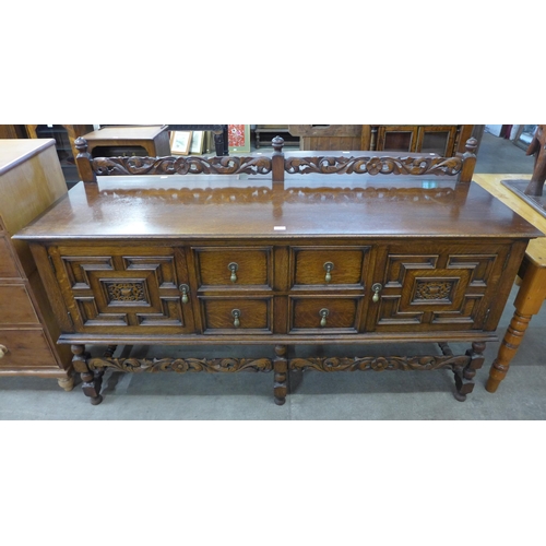 180 - An early 20th Century Jacobean Revival carved oak sideboard