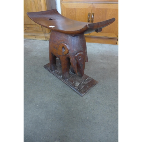 181 - An African carved hardwood elephant based stool