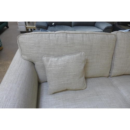 1446 - An oatmeal textured weave upholstered 3.5 seater sofa