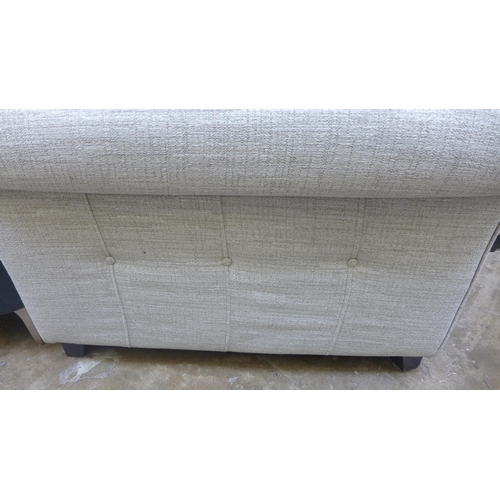 1446 - An oatmeal textured weave upholstered 3.5 seater sofa