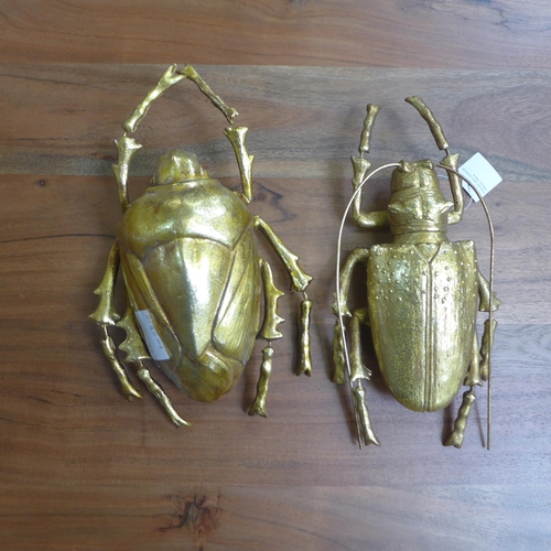 1457 - A pair of wall mounted gold beetles