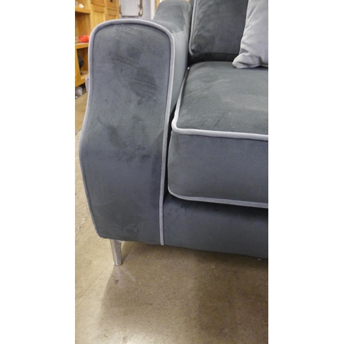 1514 - A mid grey velvet upholstered small three seater sofa with light grey piping and scatter cushions on... 