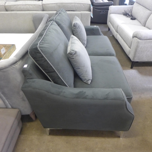 1514 - A mid grey velvet upholstered small three seater sofa with light grey piping and scatter cushions on... 