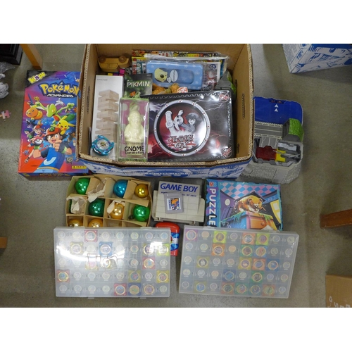 1056 - A collection of toys and games; Beyblades, Pokemon Waps, a GameBoy Portable Carry-All containing a G... 