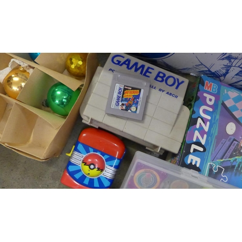 1056 - A collection of toys and games; Beyblades, Pokemon Waps, a GameBoy Portable Carry-All containing a G... 