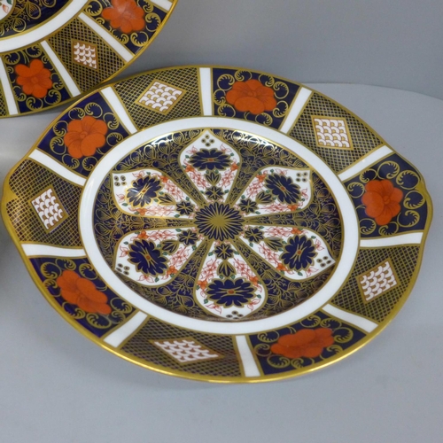 610 - Two Royal Crown Derby 1128 Imari bread and butter plates, first quality and a restored dinner plate