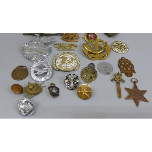 626 - A collection of military badges and a Pacific Star medal