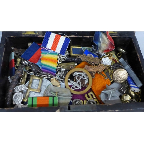 626 - A collection of military badges and a Pacific Star medal