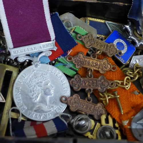 626 - A collection of military badges and a Pacific Star medal