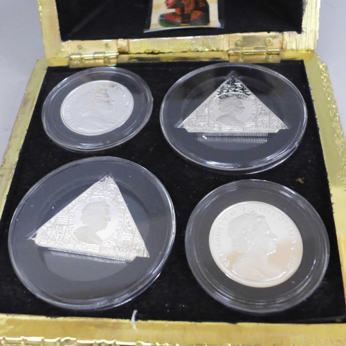 648 - A pyramid box with four silver proof Isle of Man 2008 Tutankhamun coins, each 28g