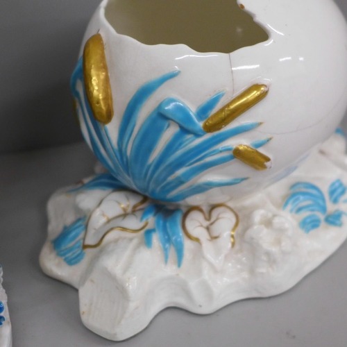 650 - A German porcelain figural spill holder and egg ornament, both a/f