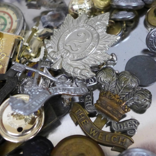 690 - A collection of military badges, buttons and medals