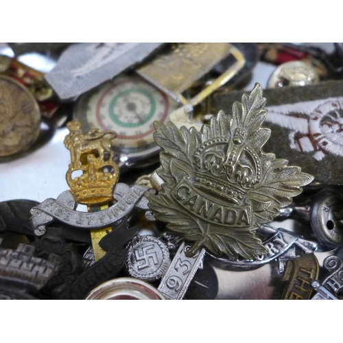 690 - A collection of military badges, buttons and medals