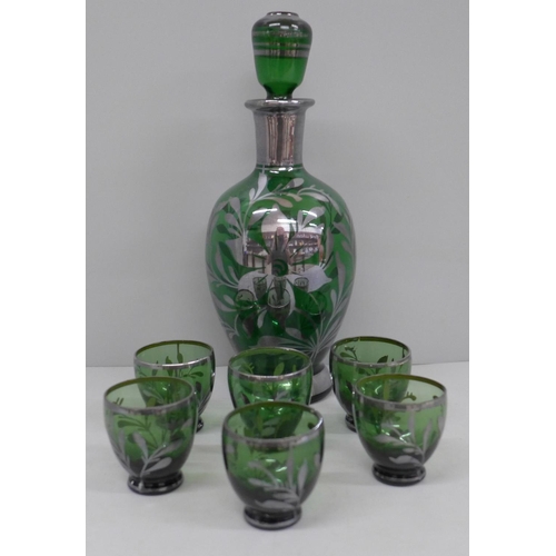 695 - A liqueur set; silver overlay green glass decanter and six glasses