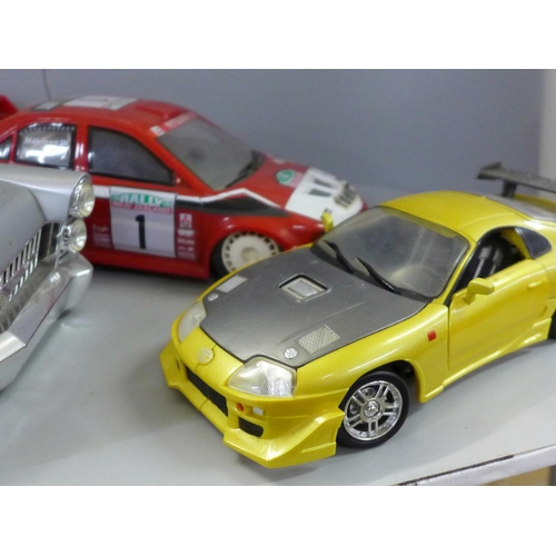 755 - A remote control rally car, no remote controller and three other model cars