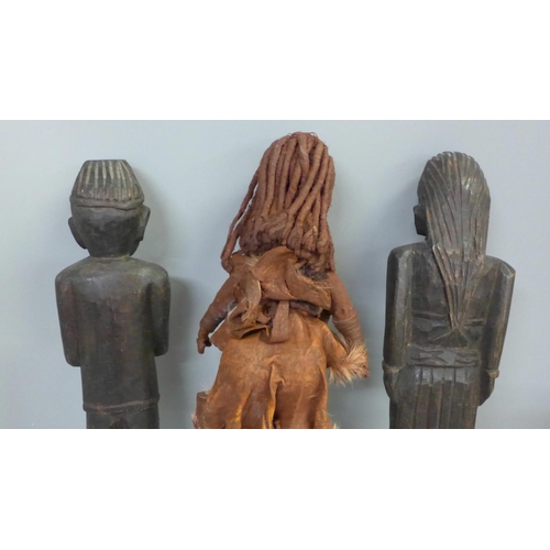 762 - An African leather covered fertility figure, two carved African figures and a carved chillum pipe