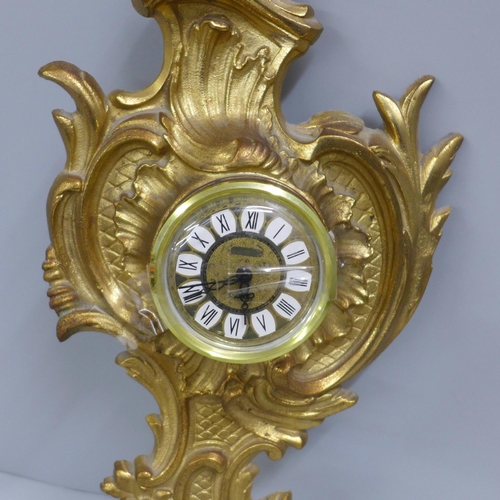 785 - A heavy cast brass wall timepiece, 34cm