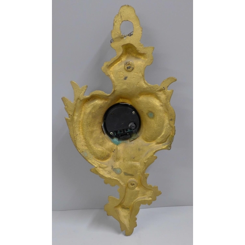 785 - A heavy cast brass wall timepiece, 34cm