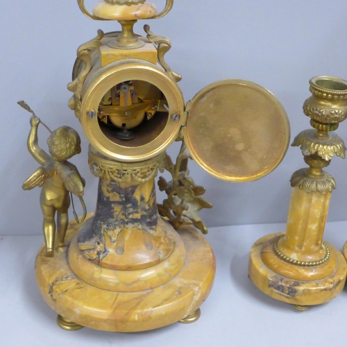 797 - A 19th Century French yellow marble and gilt metal clock garniture, with cupid, the porcelain dial m... 