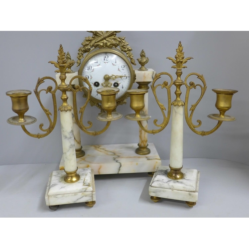 798 - A French white marble and gilt metal clock garniture with porcelain dial, 38cm