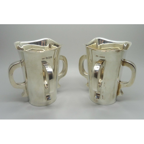 840 - A pair of silver Mappin & Webb Irish Mether four handled vessels, Sheffield 1938, 620g total weight,... 