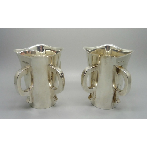 840 - A pair of silver Mappin & Webb Irish Mether four handled vessels, Sheffield 1938, 620g total weight,... 