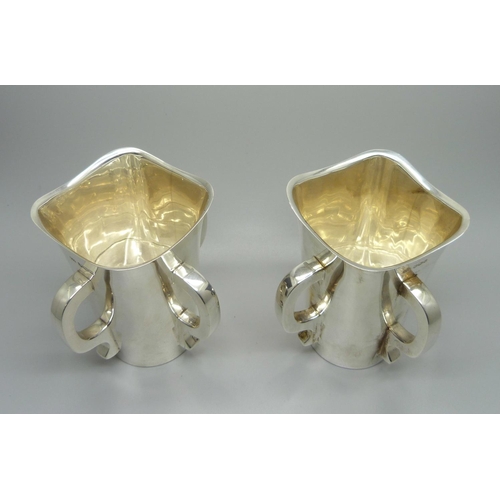 840 - A pair of silver Mappin & Webb Irish Mether four handled vessels, Sheffield 1938, 620g total weight,... 