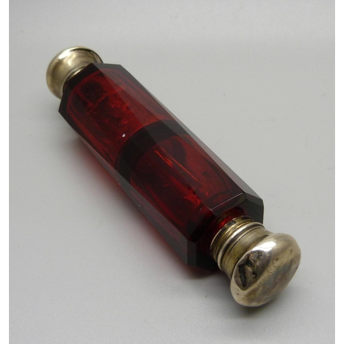 854 - A ruby glass double scent bottle, (tops dented)