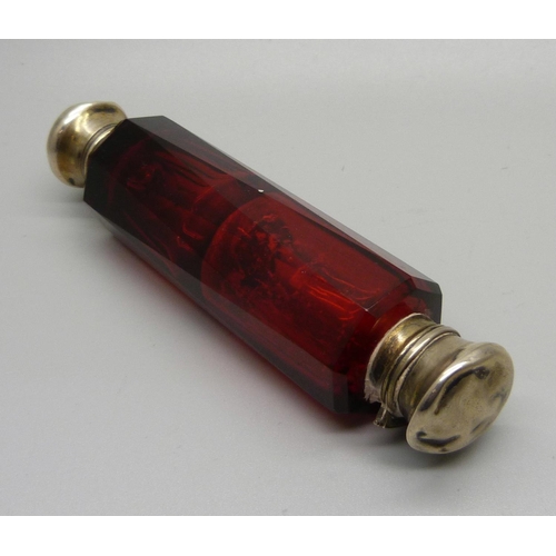 854 - A ruby glass double scent bottle, (tops dented)