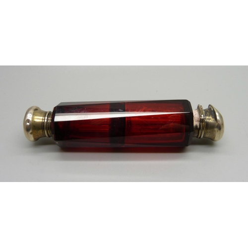 854 - A ruby glass double scent bottle, (tops dented)