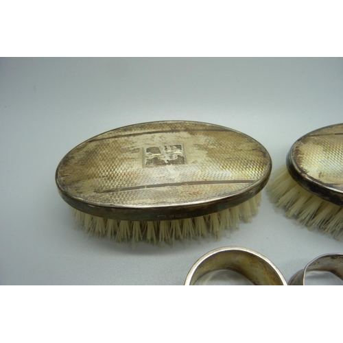 870 - Two silver backed brushes and two silver napkin rings