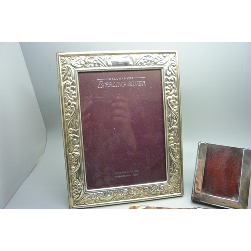 875 - A silver photograph frame, 17cm x 22cm, and two other silver mounted frames