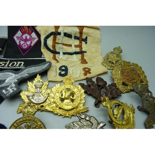 879 - A collection of military badges, etc.