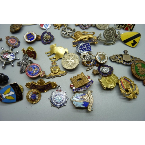 881 - A collection of enamel badges and pins