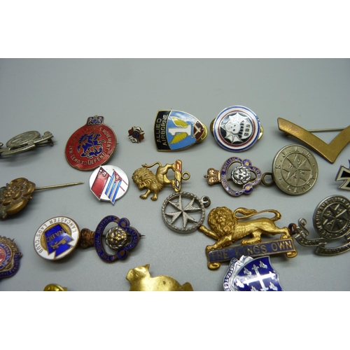 881 - A collection of enamel badges and pins