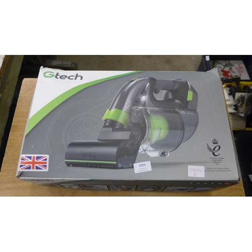 2066 - A G-Tech multi cordless hand held vacuum cleaner, power brush attachments, extension tube and charge... 