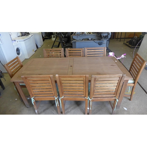 2225 - A teak garden table and 8 chairs