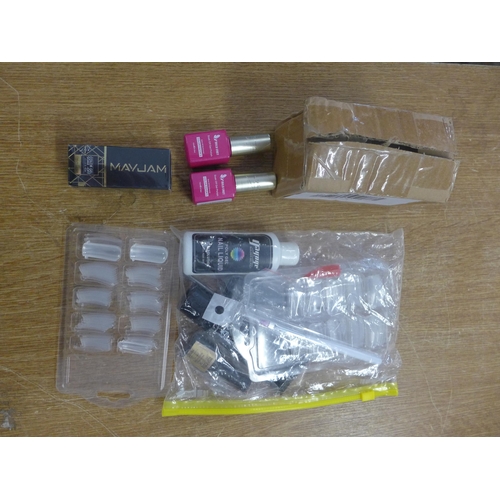 2395 - A large bag of unused cosmetics including pink nail varnish and fake nail kits