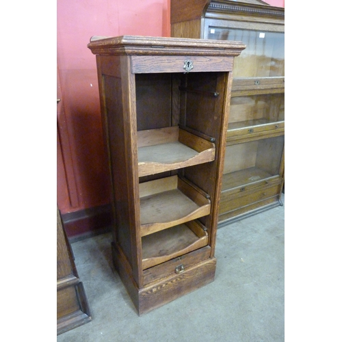 104 - An early 20th Century oak tambour front filing cabinet