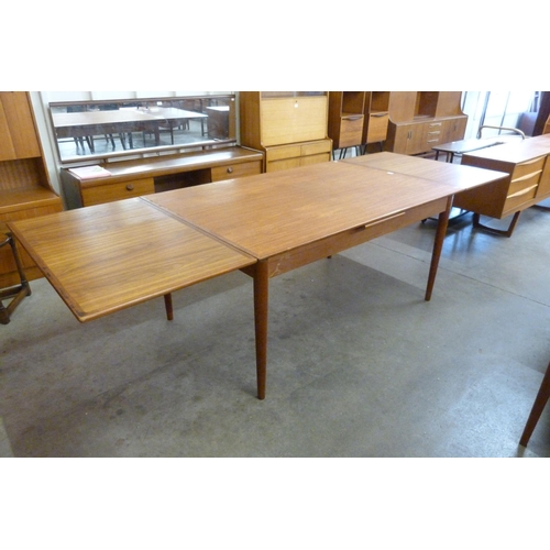 11 - A Danish Koefoeds Hornslet teak extending dining table, designed by Niels Koefoed